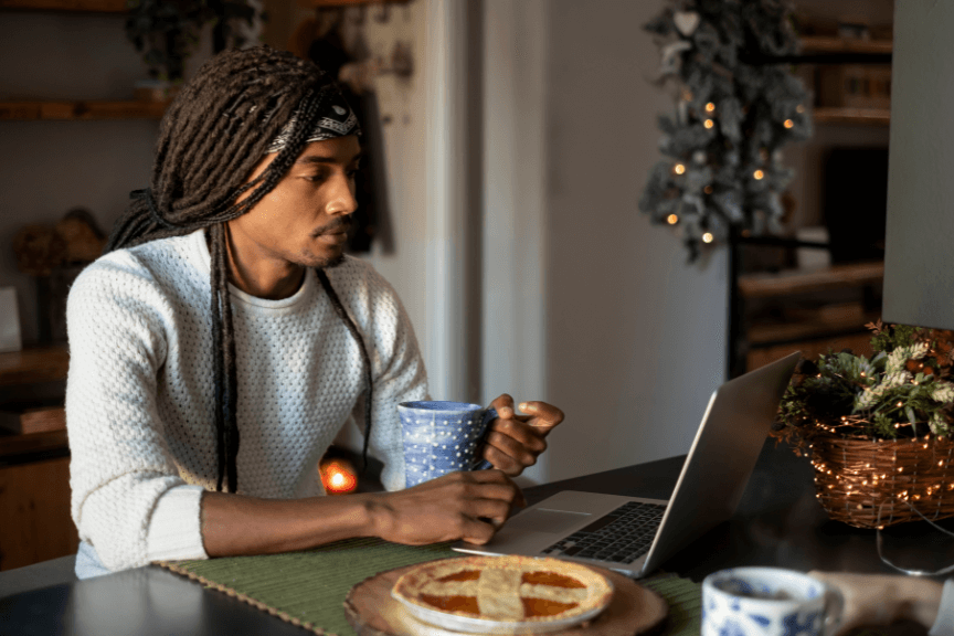 A young adult browsing the internet on a laptop